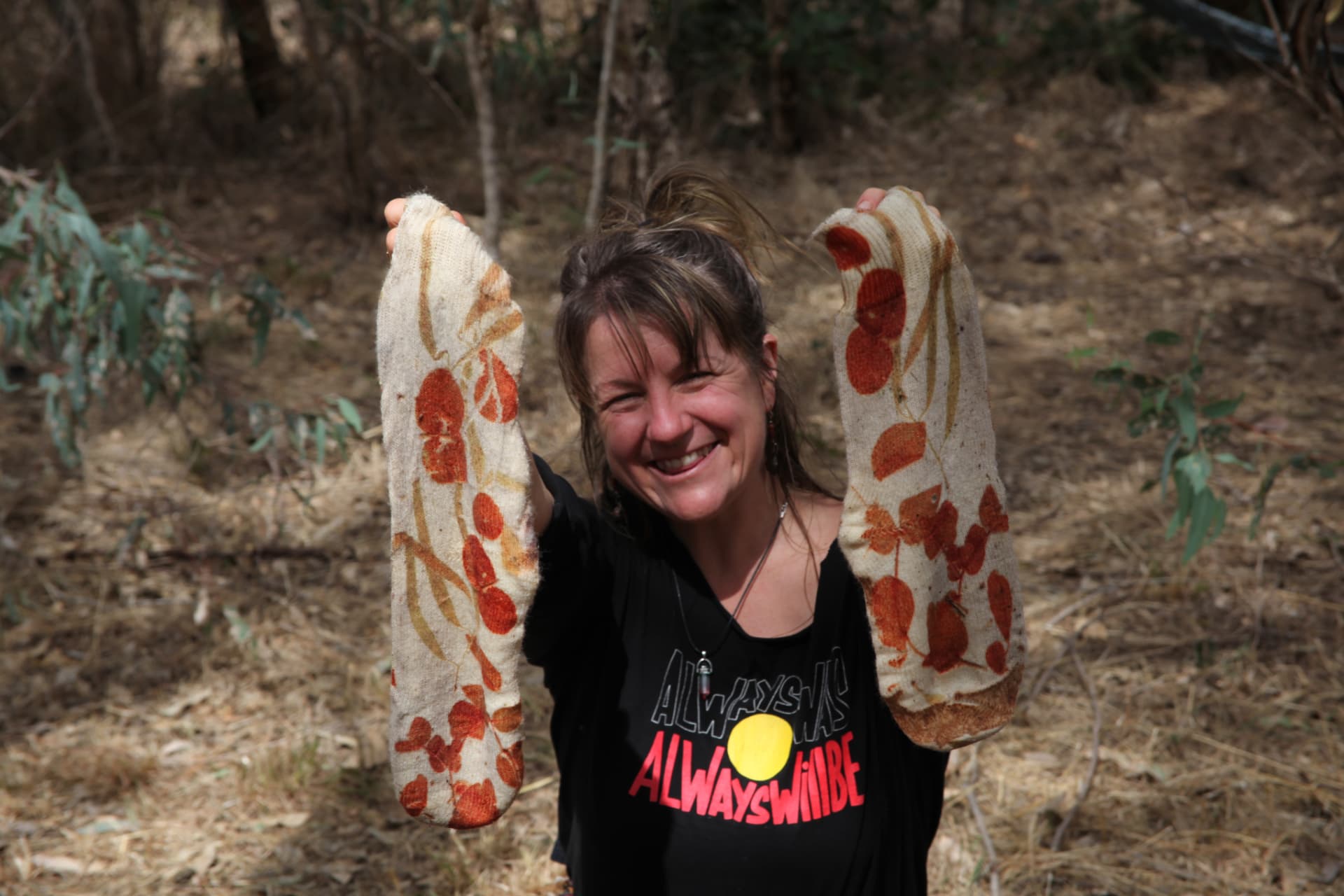 Nectar holding up socks naturally dyed with eucalyptus leaves