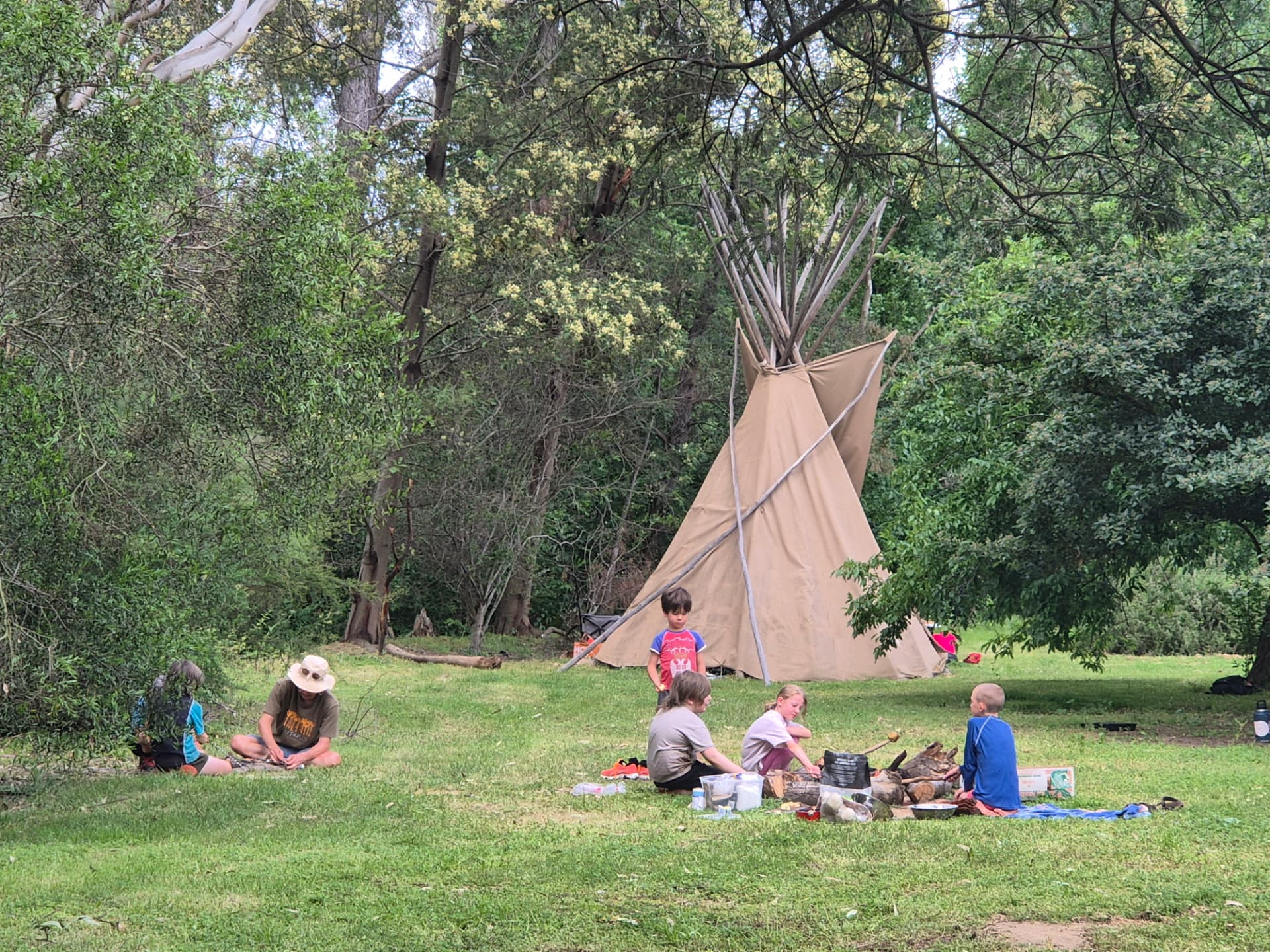 Children sharing bush activities beside the Punk Caterpillar canvas shelter